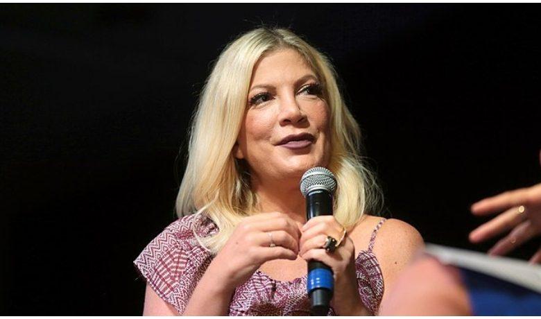 Tori Spelling speaks at an event.