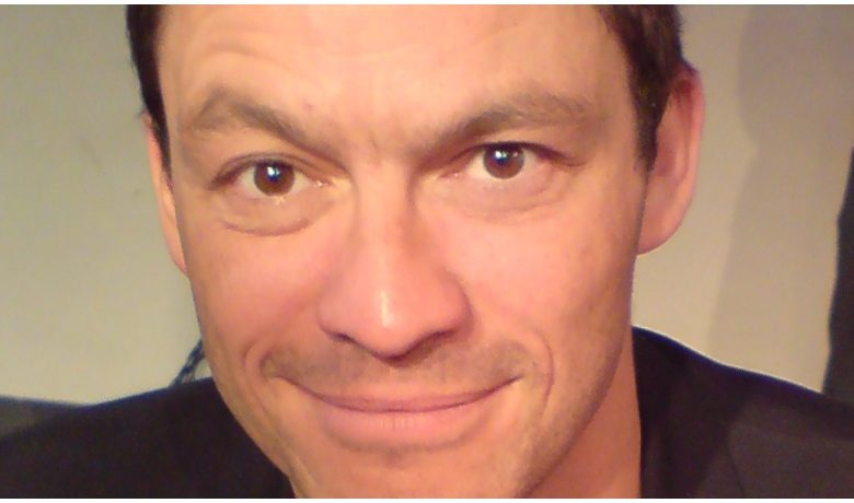 Actor Dominic West smiles for the camera.