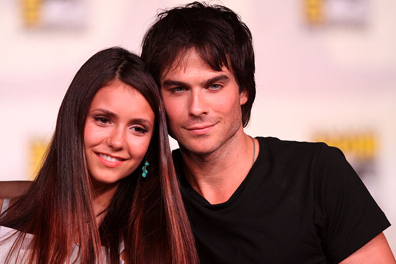 Nina Dobrev and Ian Somerhalder smile for the camera.