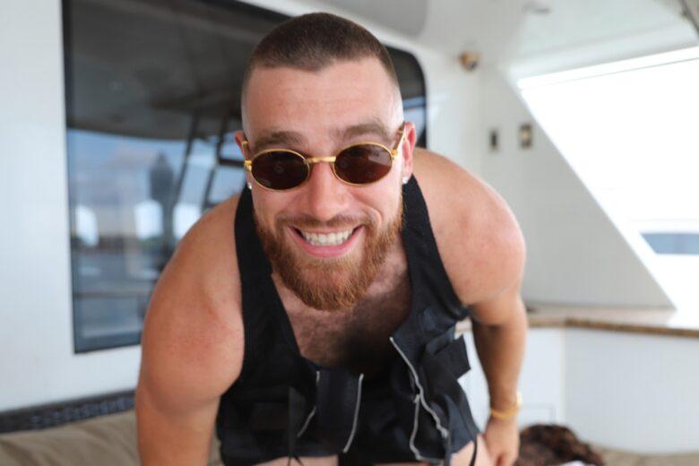 Travis Kelce smiling on a boat.